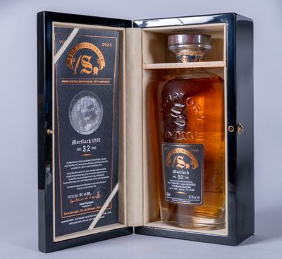 a bottle of whisky in a wooden box with a label on it