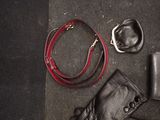 a pair of boots, a wallet, and a belt on the floor