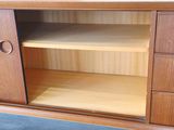 an image of a wooden cabinet with shelves and drawers