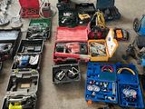a lot of tools sitting on the floor in the garage