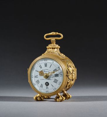 an image of a gold clock with roman numerals on the face