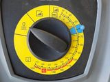 a close up of a machine with a yellow button on it
