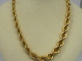 a close up of a gold necklace on a mannequin mannequin