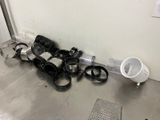 a bunch of clutter on the floor next to a trash can