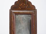 an old wooden frame with a bell hanging from it ' s side