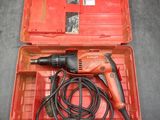 a red box with a drill and a cord in it