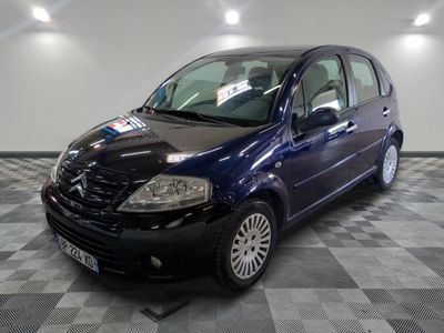 la photo d'une petite voiture bleue garée sur un sol en damier