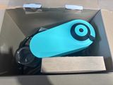 a blue water bottle in a box with a black lid
