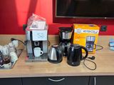 a coffee maker, coffee pot, coffee maker, and other items on the counter