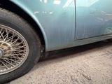 a close up of a car with a tire on the ground