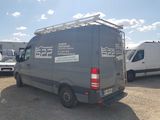 a van that is parked in a lot with other vehicles