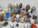 many different types of painted eggs on a white surface