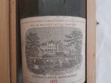 a bottle of wine that is in a wooden case