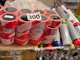 many rolls of tape in a wire basket on the floor