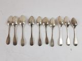 six spoons are lined up next to each other on a table