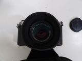 a camera with a lens attached to it on a white surface