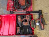 a red tool box with tools in it on the floor