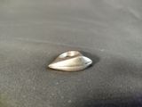 a silver ring sitting on top of a black cloth