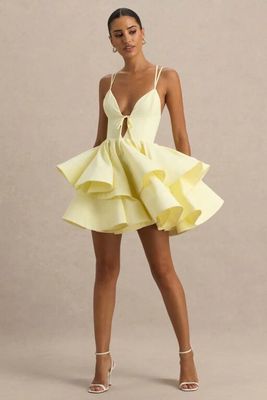 a woman in a yellow dress poses for a photo