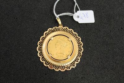 a close up of a gold coin on a black surface