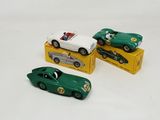 three toy cars that are sitting on top of a box