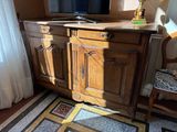 a television on top of a wooden cabinet in a living room