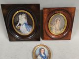 two framed pictures of a lady and a lady in a blue dress