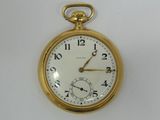 a gold pocket watch on a white surface