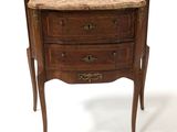 a small wooden chest of drawers with a marble top