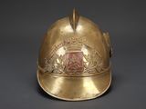 a gold helmet with a crest on it on a black background