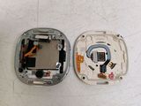 two pieces of metal that have been removed from the back of a cell phone
