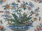a decorative plate with flowers and birds on it