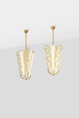 pair of gold plated metal and glass earrings on a white background