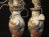 two vases that have been decorated with flowers and birds