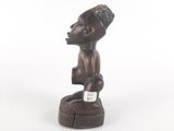 an image of a wooden statue of a man with a cigarette in his mouth