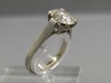 a close up of a ring with a diamond on it