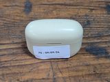 a small white box on a wooden table with a tag on it