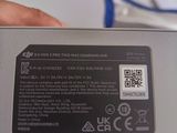 a person holding a small electronic device in their hand
