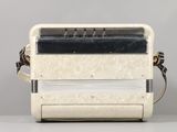 a white and black accordion sitting on a table