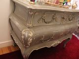 a dresser with a mirror on top of it in a room