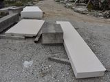 a pile of concrete blocks on the ground next to a building
