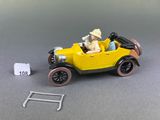a yellow toy car with a man and a dog in it