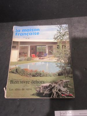 a book on the table with a picture of a house in the background
