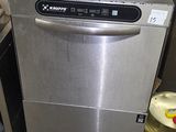 a silver dishwasher sitting next to a stove in a kitchen