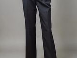 a mannequin woman wearing a white top and black pinstripe pants