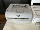 a printer sitting next to a printer on a table