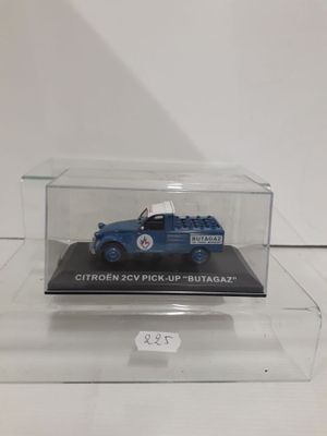 the blue truck is in a clear box on a white surface