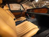 the interior of a car with tan leather seats and wood trims