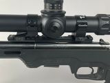 a close up of a rifle with a scope on a white background