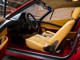 the interior of a red sports car with a yellow leather seat